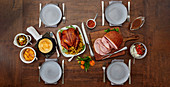 Festive menu with ham and poultry roast, side dishes and sauces