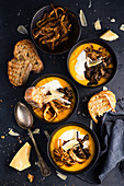 Carrot pumpkin cream soup with pulled pork, thick cream croutons and Parmesan cheese