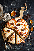 Chocolate cake with caramel cream, chocolate bars and salty caramel