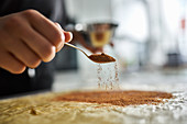 Preparing cinnamon roll cake: sprinkling dough with cinnamon