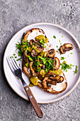 Toast with garlic cheese mushrooms green pesto and parsley