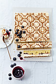 Blueberry cake with cinnamon cream with a filigree pattern