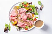 Roast beef with a honey and mustard sauce and salad