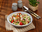 Spätzle (soft egg noodles) salad with cucumber, capers and radishes