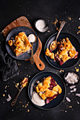 Portions of shortbread with coconut plums and crumble served with natural yogurt