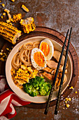 Ramen soup with meat, broccoli, corn on the cob and egg