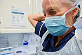 Nurse putting on face mask