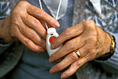 Elderly woman holding panic alarm