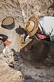 Archaeologist uncovering artefacts