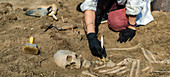 Archaeologist excavating skeleton