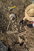 Archaeologist excavating skeleton