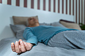 Woman lying in bed meditating