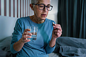 Woman taking melatonin pills