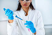 Researcher pipetting sample