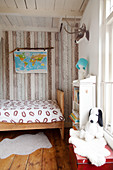 Wooden bed and wood-clad wall in child's bedroom