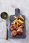 Tenderloin steak in striped bacon with vegetable fries