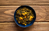 Indian Palak paneer on wooden rustic background