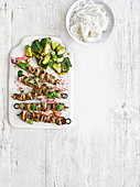 Ribbon beef skewers with radish pickles and smashed cucumber