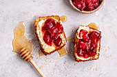 Corn bread toast with butter, roasted strawberries and honey