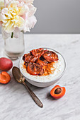 Bowl of yogurt with roasted apricots and coconut sugar