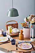 Set table with teapot, vases and flowers