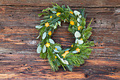 Festive wreath made from various branches and decorations cut out of orange peel