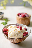 Homemade caramel vanilla ice cream with frozen raspberries