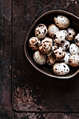 Quail eggs in a bowl with negative space