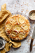 Decorated lemon cake on a cooling rack with napkin