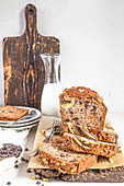 Banana bread with chocolate and walnuts, on a wooden board