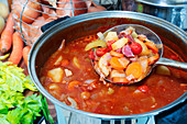 Vegetable and ham hock soup in a pot