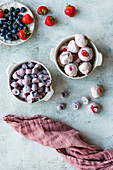 Yogurt bites with blueberries and strawberries in two ceramic bowls