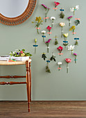 Various flowers stuck on wall with masking tape