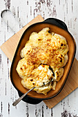 Cauliflower with cheese sauce in a baking dish