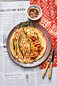 Korean pancakes with kimchi, spring onions and soy sauce