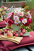Autumn bouquet with roses, autumn anemone, decorative apples and apples