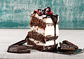 Black forest cake slice with chocolate biscuits and cream with cherries