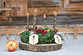 Advent wreath with numbered biscuits and wooden candles