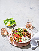 Barley and couscous tabbouleh with meatballs, tzatziki and zoodles