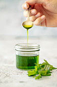 Homemade herb oil with parsley and lovage (vegan)