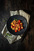 Octopus with fregola, tomatoes, garlic and thyme