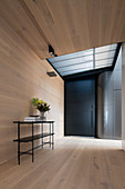 Foyer with wood-clad floor, wall and ceiling