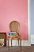Gilded medallion chair against pink wall