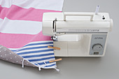 Sewing striped cloth and oilcloth backing together