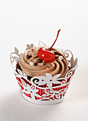 Chocolate cupcake with chocolate cream and cherry
