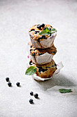 Homemade blueberry muffins in paper cupcake holder in stack