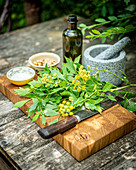 Ingredients for lovage pesto on an outdoor table