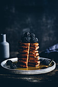 Pumpkin pancakes with blackberries and maple syrup