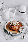 Pumpkin pancakes with white currants topped with maple syrup