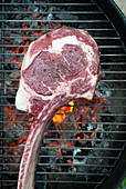 Tomahawk steak on charcoal grill